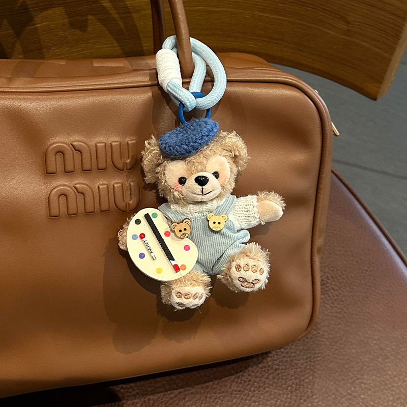 画家ダフィーの白いセーターと青いズボン