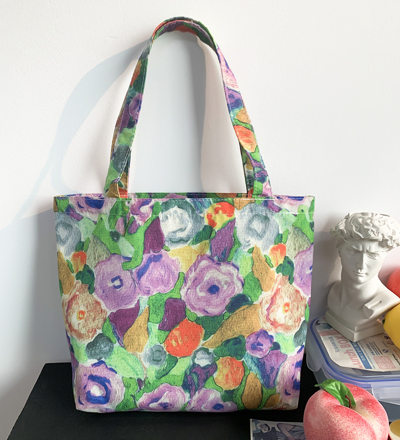 紫緑の花のハンドバッグにジッパーがある