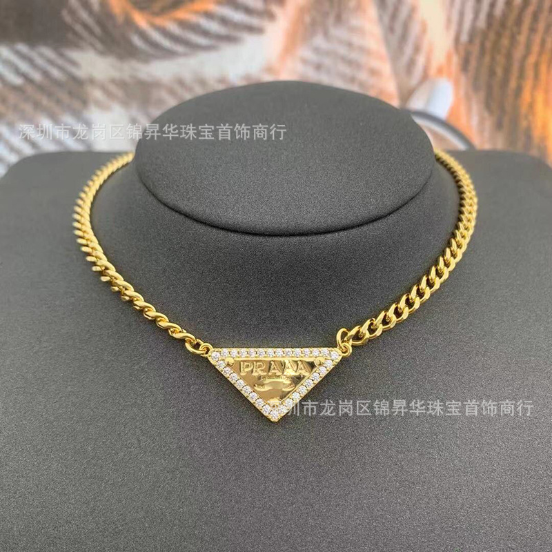 ダイヤモンドの三角形の金色のネックレス